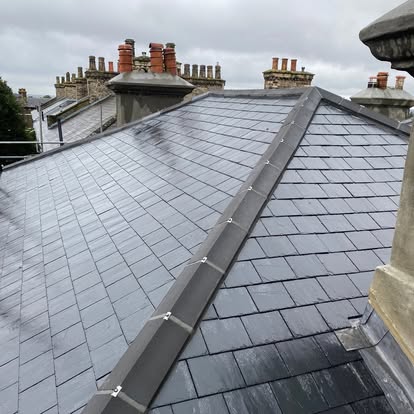 Slate hip roof with ridge tiling